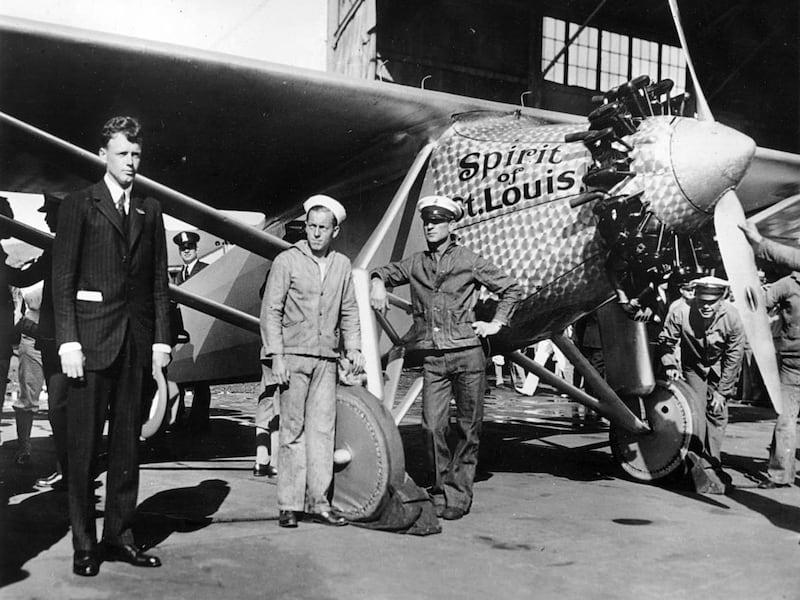 Ten years after Col. Charles A. Lindbergh's epic flight to Paris, he is photographed with his monoplane, "The Spirit of St. Louis."
