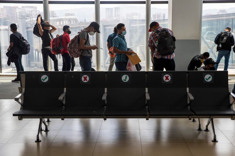 Passengers wait to board a humanitarian flight to Canada at the La Aurora international airport in Guatemala City, Thursday, Sept. 17, 2020. Authorities are preparing for the reopening of the airport on Friday as part of the gradual reopening of the country’s borders by allowing national flights and some duly authorized international flights.
