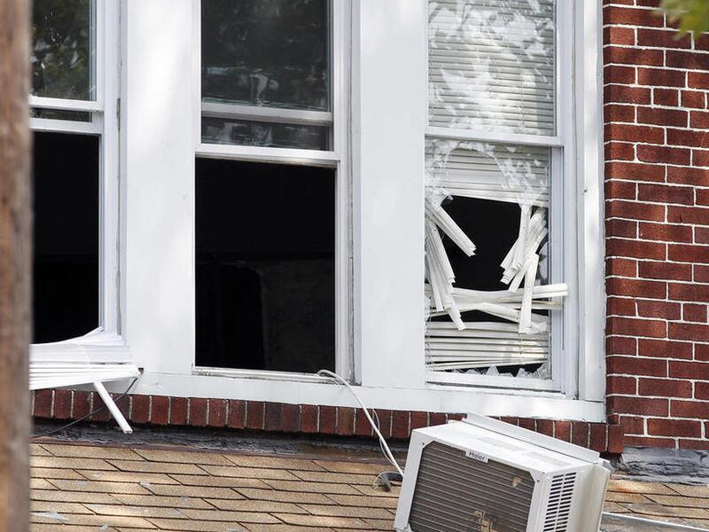 An air conditioner rests on a porch roof at 1415 Kaighn Ave., in Camden, N.J., Wednesday, Aug. 22, 2012, after police in Camden say a 2-year-old boy was decapitated, apparently by his mother, and his head left in the freezer of their home before woman fat