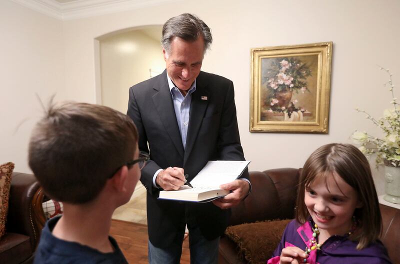 U.S. Senate candidate Mitt Romney signs his book for supporters at the home of Calvin Musselman, Republican candidate for District 9 of the Utah House of Representatives, in West Haven on Monday, Oct. 8, 2018.