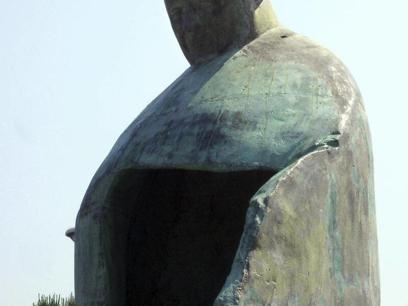 A giant bronze sculpture portraying Pope John Paul II is displayed outside Rome's Termini train Station, Friday, May 20, 2011. The Vatican is dismayed by a giant new sculpture portraying Pope John Paul II, saying the towering bronze work outside Rome's ma