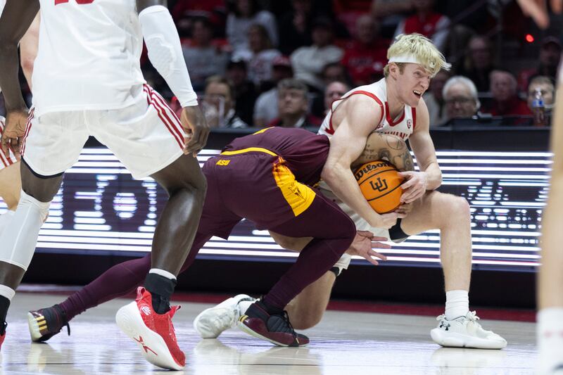 Utah Utes guard Hunter Erickson (0) fights for the ball against Arizona Sun Devils guard Frankie Collins (1) at the Huntsman Center in Salt Lake City on Saturday, Feb. 10, 2023.