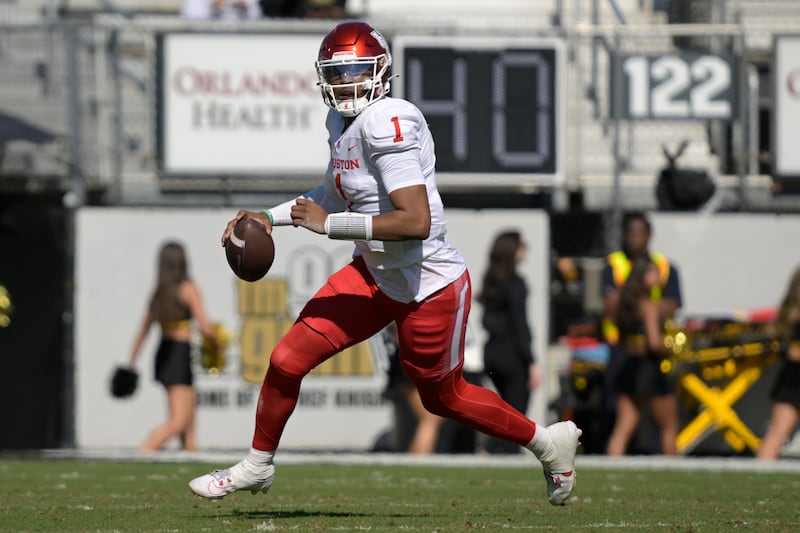 Houston quarterback Donovan Smith looks for a receiver during game against Central Florida, Saturday, Nov. 25, 2023, in Orlando, Fla.