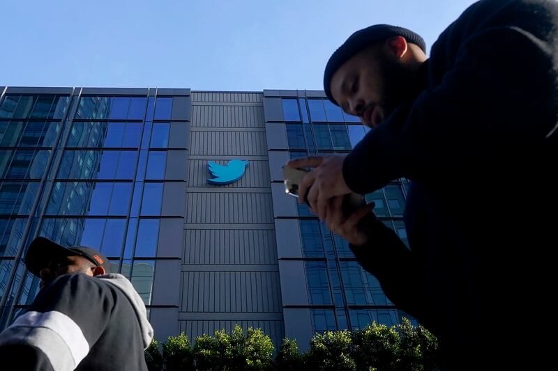 People walk outside Twitter headquarters in San Francisco.