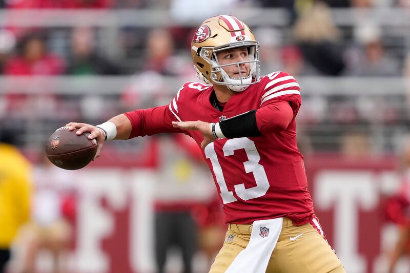 San Francisco 49ers quarterback Brock Purdy (13) throws a touchdown pass to running back Christian McCaffrey in Santa Clara, Calif., Sunday, Dec. 11, 2022.