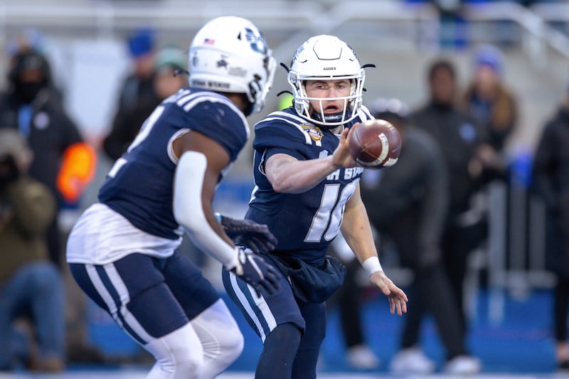 Utah State quarterback McCae Hillstead (10) pitches the ball to Robert Briggs Jr. during the Famous Idaho Potato Bowl game against Georgia State, Saturday, Dec. 23, 2023, in Boise, Idaho. The former Aggie was picked up by BYU after entering the transfer portal.