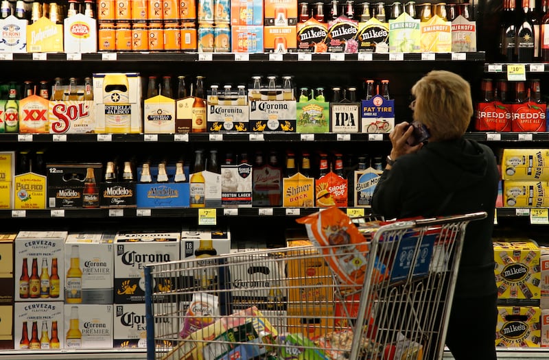 A customer looks over the beer selection at Crest Foods in Oklahoma City, Monday, Oct. 1, 2018. Beginning Monday grocery stores and convenience stores in Oklahoma can legally sell wine and strong beer.