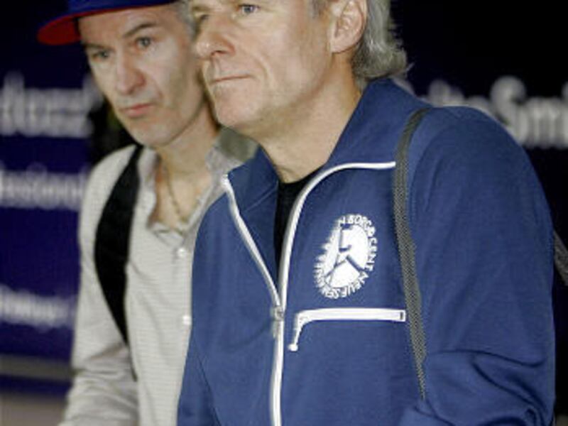 Veteran tennis stars Bjorn Borg of Sweden, right, and John McEnroe of the United States walk together after arriving in Bangkok, Thailand, on Nov. 21, 2008.