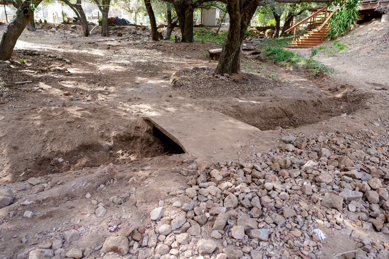 A small wood footbridge is visible in after volunteers dug it out during a service project in El Cariso, California, on March 29, 2025.