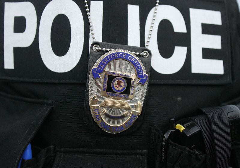 Before serving a search warrant in Tooele ICAC officers don bullet proof vests.