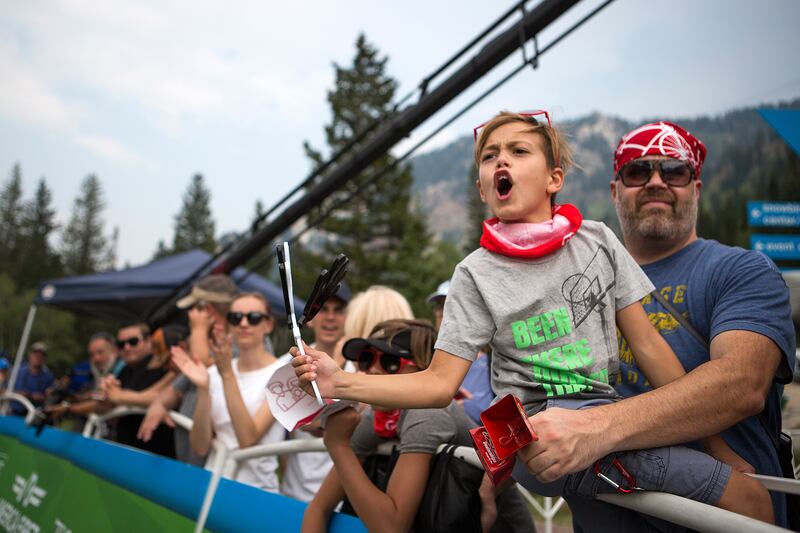 Kyson Lambert, 10, cheers as Richard Lambert holds him by the finish line of stage five of the Tour of Utah at Snowbird Resort on Saturday, Aug. 11, 2018.