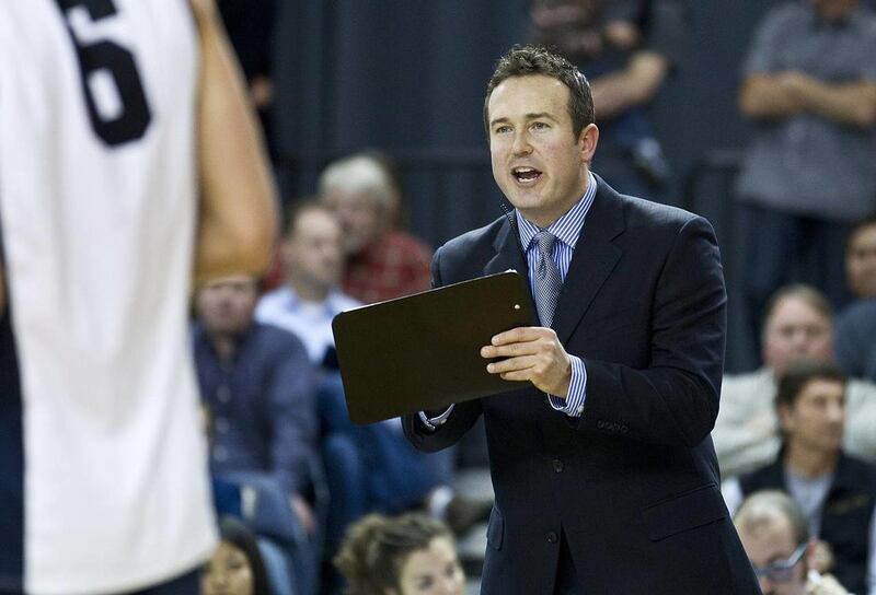BYU head coach Chris McGown makes adjustments during the fourth set of a volleyball match against USC.