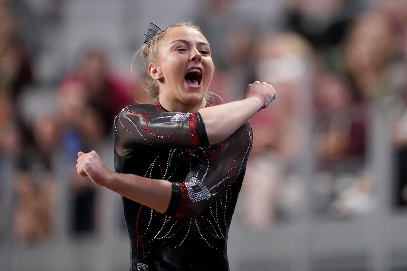 Utah’s Lucy Stanhope celebrates after competing on the vault during the NCAA college women’s gymnastics championships on Thursday, April 14, 2022, in Fort Worth, Texas.
