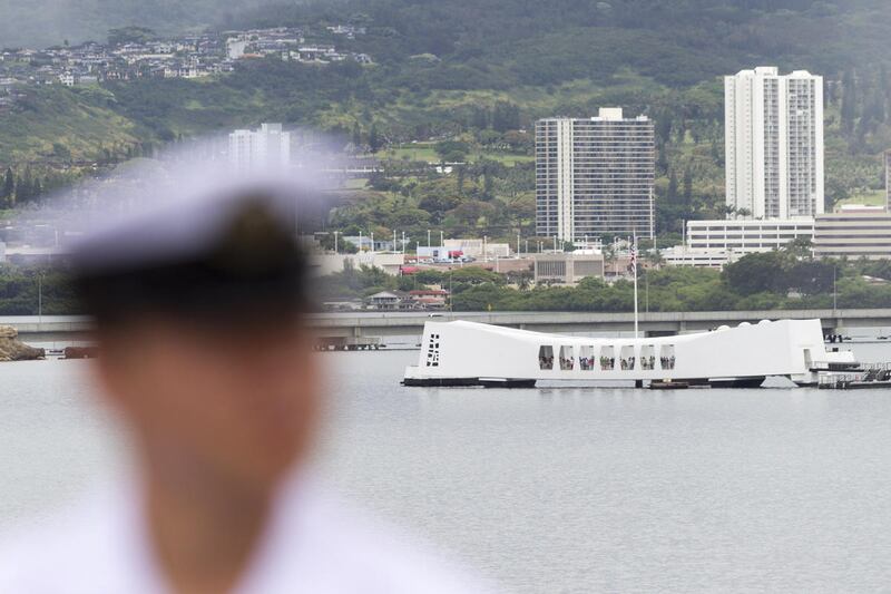 With the USS Arizona memorial in the background, a Japanese sailor stands on the deck of the Japanese Maritime Self Defense Force naval ship, JS Ise, Saturday, July 5, 2014, at Hawaii's Joint Base Pearl Harbor-Hickam. When a Vietnam veteran briefly stoppe