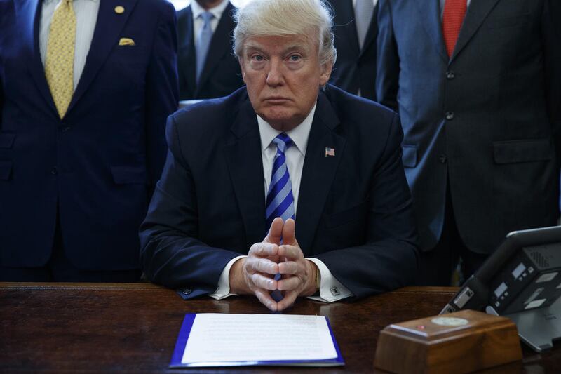 President Donald Trump pauses in the Oval Office of the White House in Washington Friday, March 24, 2017.