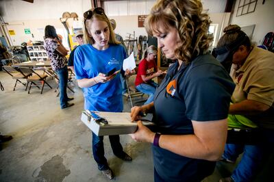 Chelsea Bowen, a Pennsylvania horse trainer, purchases wild horses during an auction at the Wild Horse and Burro Facility in Delta on Friday, Aug. 31, 2018.