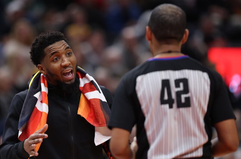Utah Jazz guard Donovan Mitchell (45) talks to referee Eric Lewis (42) as the Utah Jazz and the Portland Trail Blazers play an NBA basketball game at Vivint Arena in Salt Lake City on Wednesday, March 9, 2022. The Jazz won 123-85.
