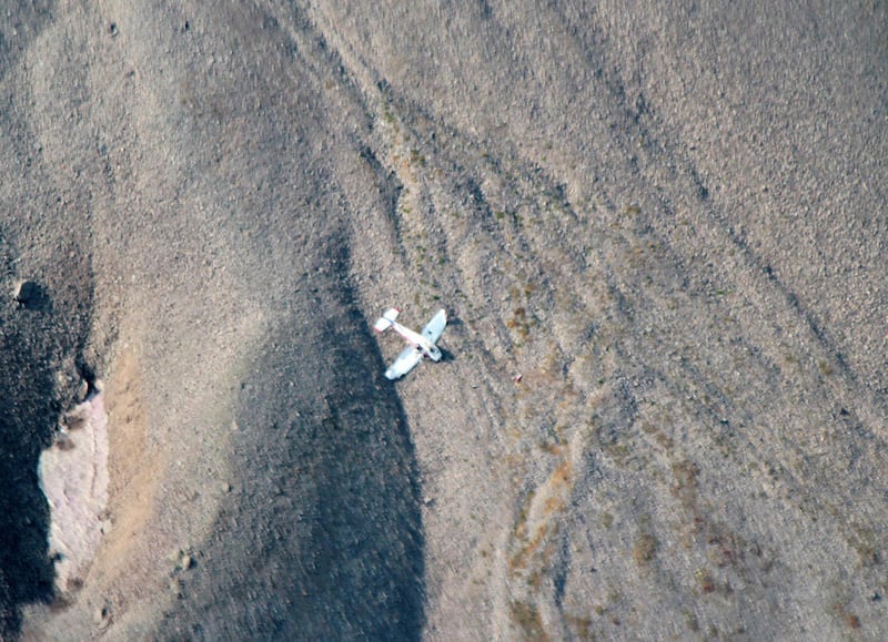This Aug. 20, 2013 photo provided by the Park County, Wy., Sheriff's Department shows the site of a plane crash that flipped over slightly injuring McKenzie Morgan in northeastern Wyoming. Morgan of Billings, Mont. got lost while flying from Greybull to