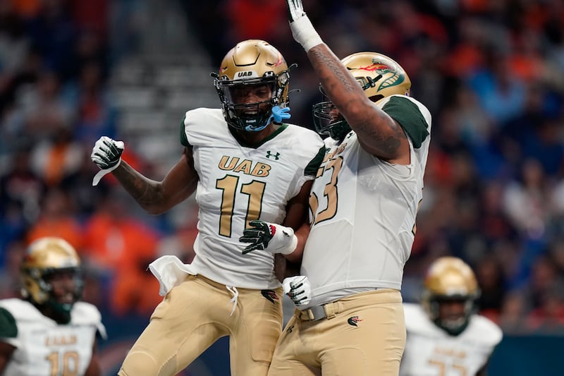 UAB wide receiver Trea Shropshire (11) celebrates a touchdown against UTSA with teammate offensive lineman Colby Ragland (53).