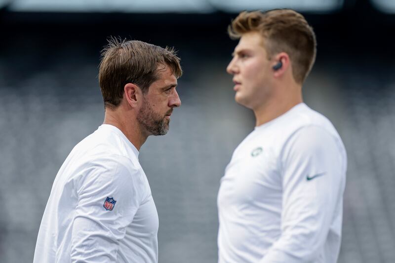 New York Jets quarterbacks Aaron Rodgers, left, and Zach Wilson practice before a preseason game.