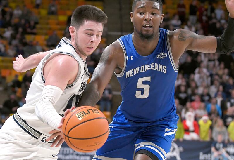 Utah State guard Rylan Jones, left, dribbles as New Orleans forward Tyson Jackson (5) defends.