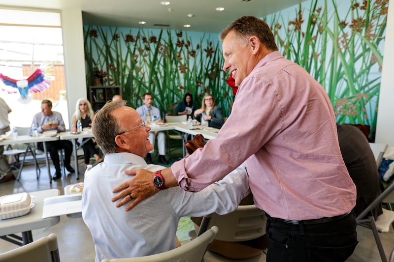 Senate President Stuart Adams shakes hand with University of Utah President Taylor Randall at the Eccles Wildlife Education Center
