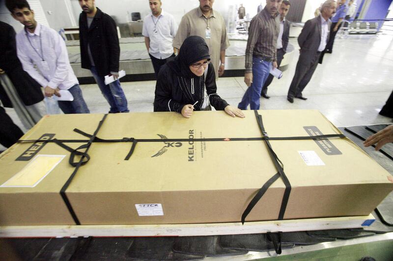 FILE - This March 31, 2012 file photo shows Fatima Alhimidi, 17, center, weeping over her mother's body at the airport after arrival from the United States south of Baghdad, Iraq. Newly released court documents in this case of an Iraqi-American mother, Sh