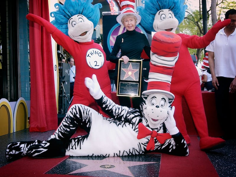 In this March 11, 2004 file photo, Audrey Geisel, widow of famed children’s book author Theodor Seuss Geisel, better known as Dr. Seuss, poses with The Cat in the Hat, foreground, and Thing 1 and Thing 2, who are characters from his books, at the dedication of Dr. Seuss’ posthumous star on the Hollywood Walk of Fame in Los Angeles.