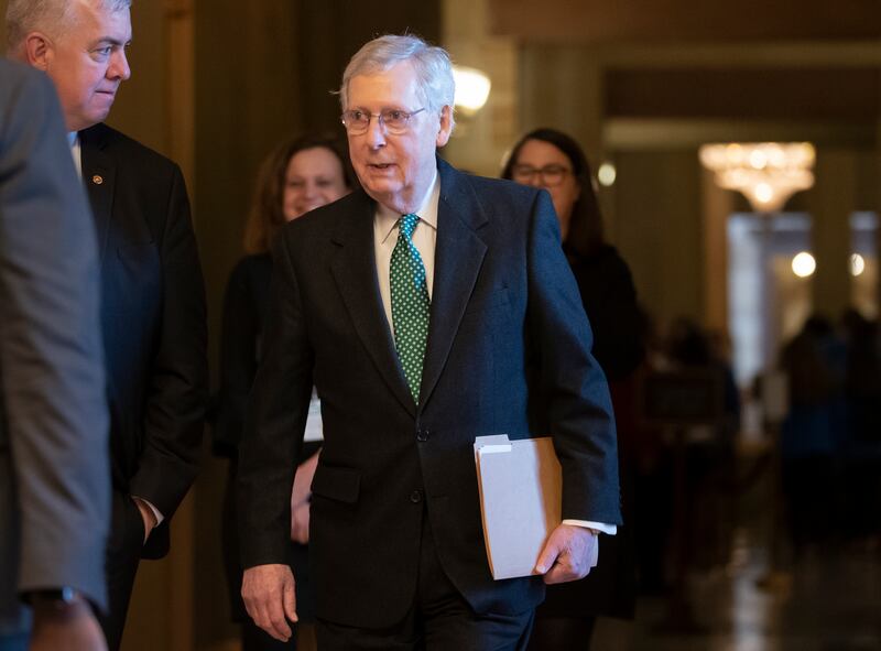 Senate Majority Leader Mitch McConnell, R-Ky., walks to the chamber as the Republican-led Senate was set to deal President Donald Trump a rebuke on his declaration of a national emergency at the Mexican border, Thursday.