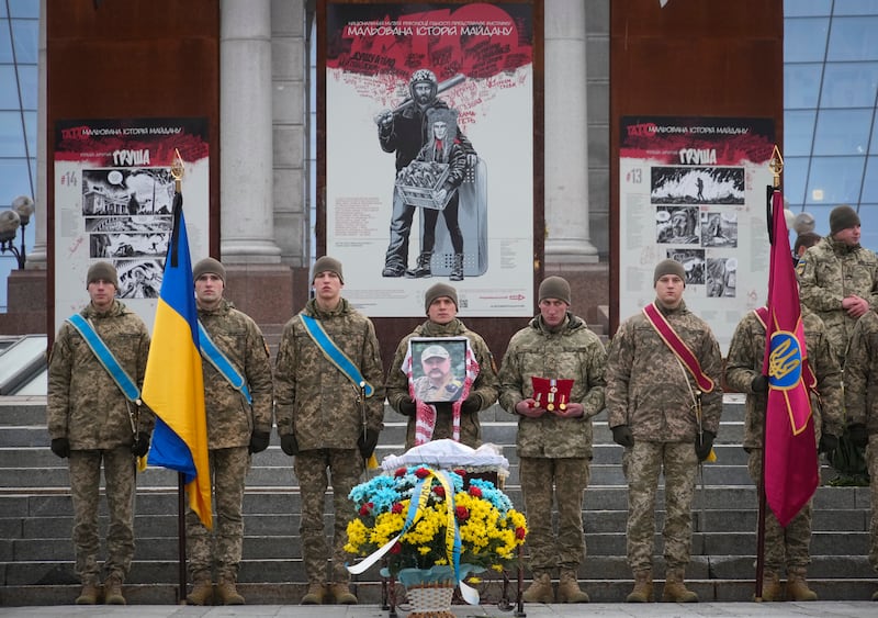 Ukrainian servicemen stand guard the coffin of their comrade during a commemoration ceremony in Independence Square in Kyiv, Ukraine.