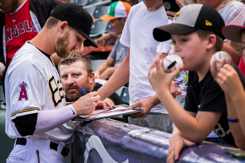 Salt Lake Bees pitcher Griffin Canning signs autographs for fans before a game between the Bees and El Paso Chihuahuas at Smith's Ballpark on Saturday, July 7, 2018.