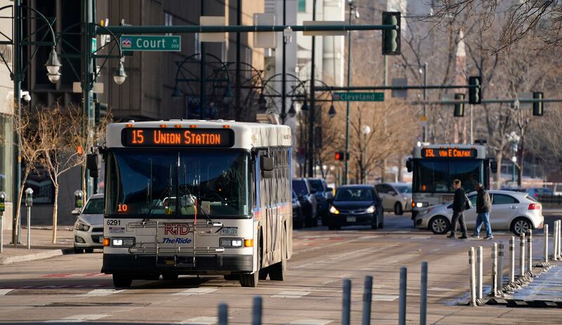 A Regional Transportation District bus moves along a lightly-traveled 15th Street Tuesday, Dec. 29, 2020, in downtown Denver.