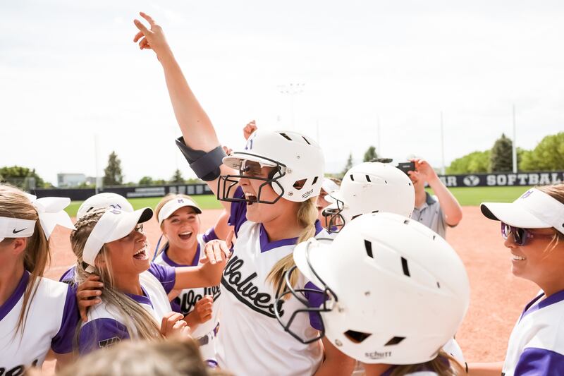 Riverton’s Chloe Woods celebrates with teammates winning the 6A softball state championship.