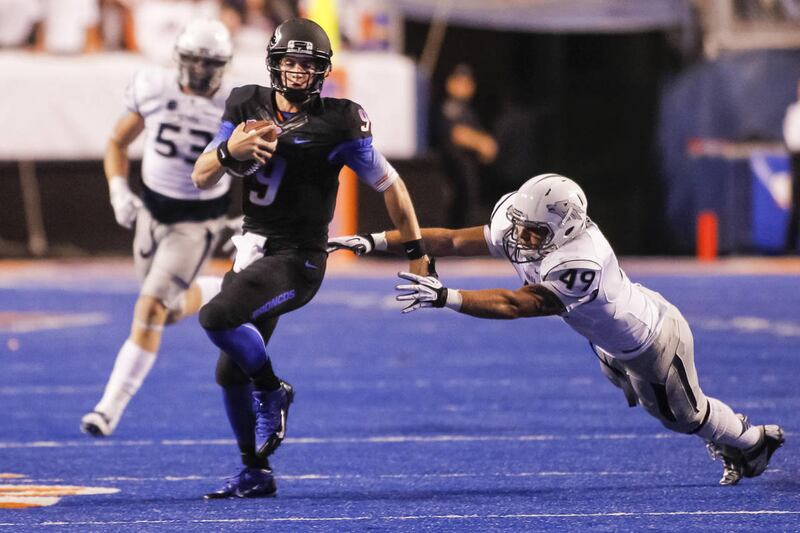Boise State quarterback Grant Hedrick (9) runs the ball past Nevada linebacker Jordan Dobrich (49) during the first half of an NCAA college football game in Boise, Idaho, on Saturday, Oct. 19, 2013. Boise State won 34-17. (AP Photo/Otto Kitsinger)