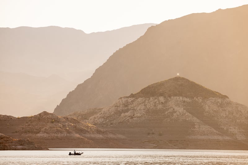 A fisherman works the waters of Lake Mead from his boat near Boulder City, Nevada.