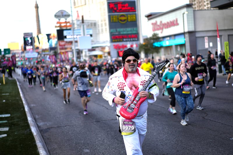 A man dressed as Elvis Presley runs along the Las Vegas Strip on Feb. 27, 2022, in Las Vegas.