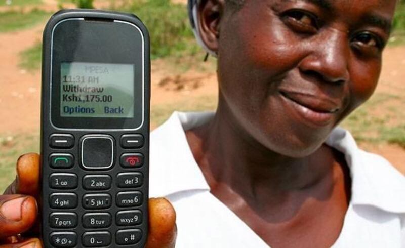 A Kenyan woman shows the message that appears on her phone when her GiveDirectly funds are available.
