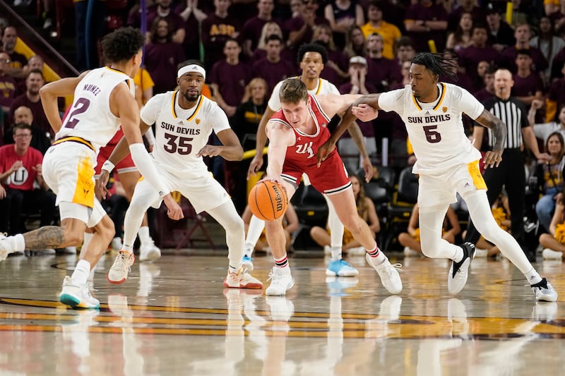 Arizona State’s Austin Nunez (2) Devan Cambridge (35) and Jamiya Neal (5) pressure Utah’s Ben Carlson (1) into a turnover during the second half of an NCAA college basketball game, Saturday, Feb. 18, 2023, in Tempe, Ariz.