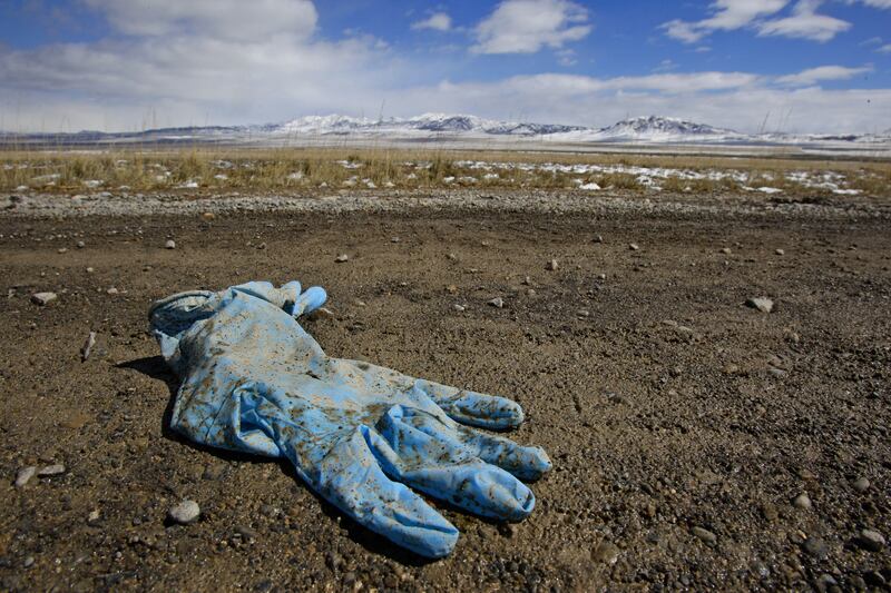 A pair of rubber gloves used by law enforcement officials lie in the middle of a remote road West of the Golden Spike Historical site March 31, 2008.