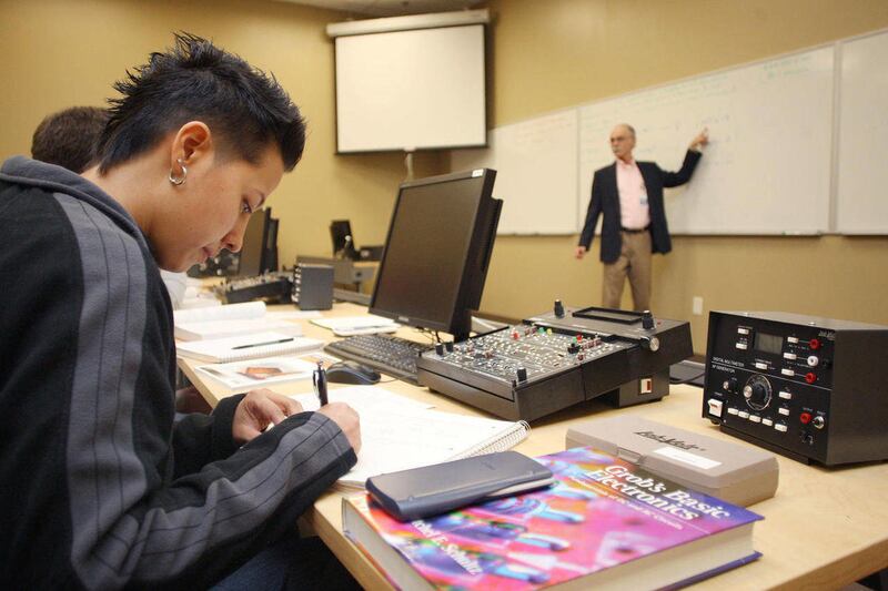 In this Jan. 13, 2011 photo, student Sharon Kenner works during a fundamentals of electricity class at the Ecotech Institute in Aurora, Colo.