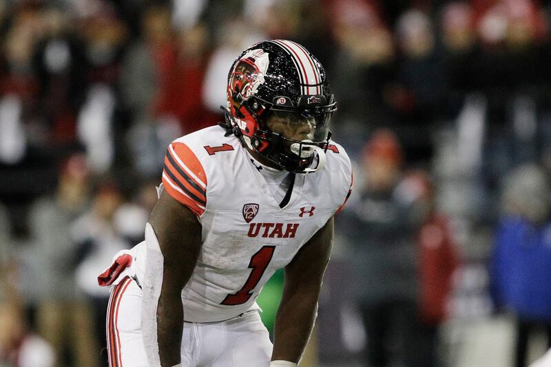 Utah running back Jaylon Glover, wearing white, lines up for a play