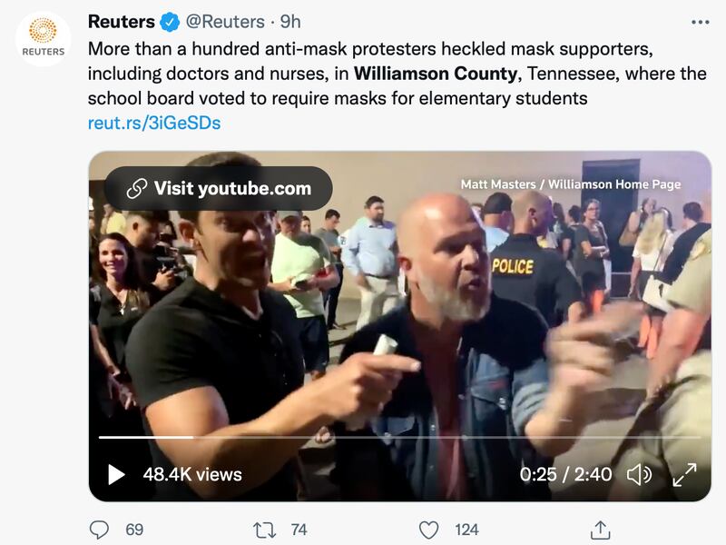 People in Tennessee argue with others during a school mask debate.