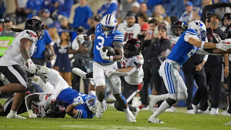 BYU running back Aidan Robbins (3) breaks free from Texas Tech linebacker Ben Roberts in Provo, Utah.