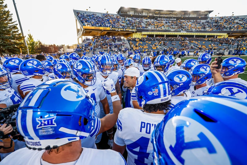 BYU players huddle on the sideline prior to their last nonconference game against Wyoming Saturday, Sept. 14, 2024, in Laramie. BYU's schedule gets appreciatively tougher moving forward, beginning with its Big 12 opener vs. No. 13 Kansas State.