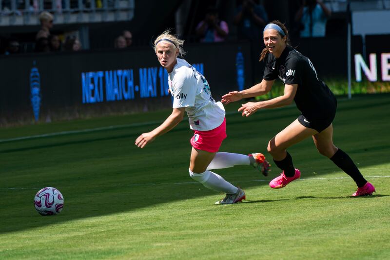 San Diego Wave defender Madison Pogarch, left, competes with Washington Spirit forward Ashley Hatch.