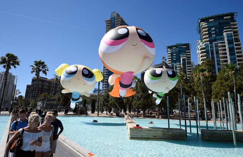 Fans walk past floating Cartoon Network Powerpuff Girls on day one of Comic-Con International held at the San Diego Convention Center Thursday, July 21, 2016, in San Diego.