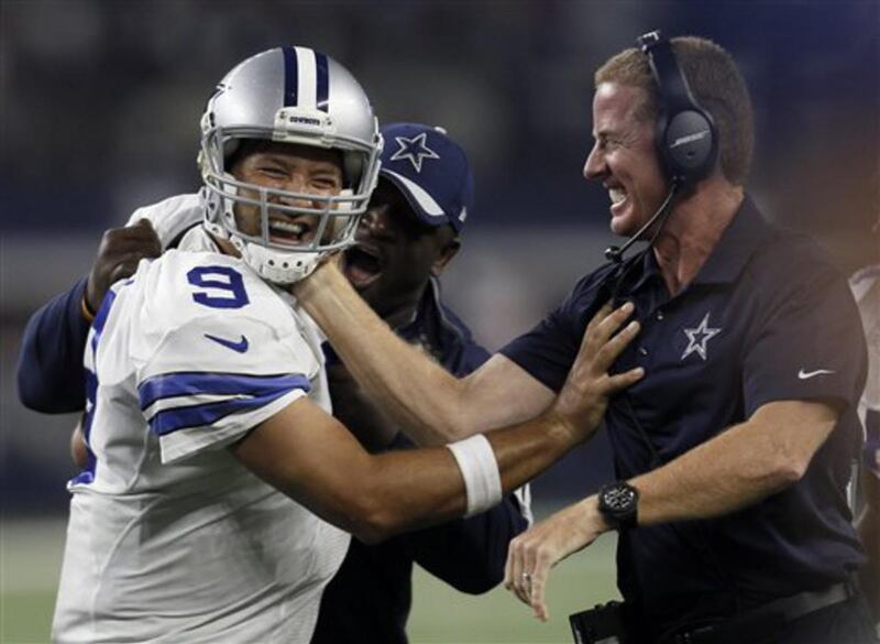 Dallas Cowboys quarterback Tony Romo and head coach Jason Garrett celebrate a last minute touchdown pass to tight end Jason Witten (82) to win against the New York Giants during the second half of an NFL football game Sunday, Sept. 13, 2015, in Arlington,