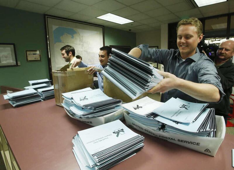 Michael Shey with Count My Vote drops off a petition with thousands of signatures to the Salt Lake county clerks office in Salt Lake City Tuesday, March 4, 2014. A majority of Utahns support the Count My Vote effort to allow candidates to get on the prima