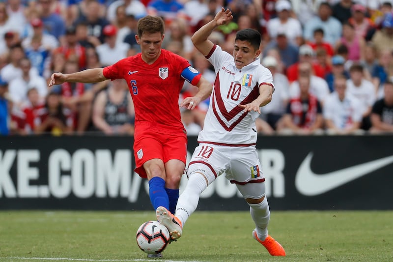 Venezuela midfielder Jefferson Savarino (10) and United States midfielder Wil Trapp (6) vie for the ball during the first half of an international friendly soccer match, Sunday, June 9, 2019, in Cincinnati. (AP Photo/John Minchillo)