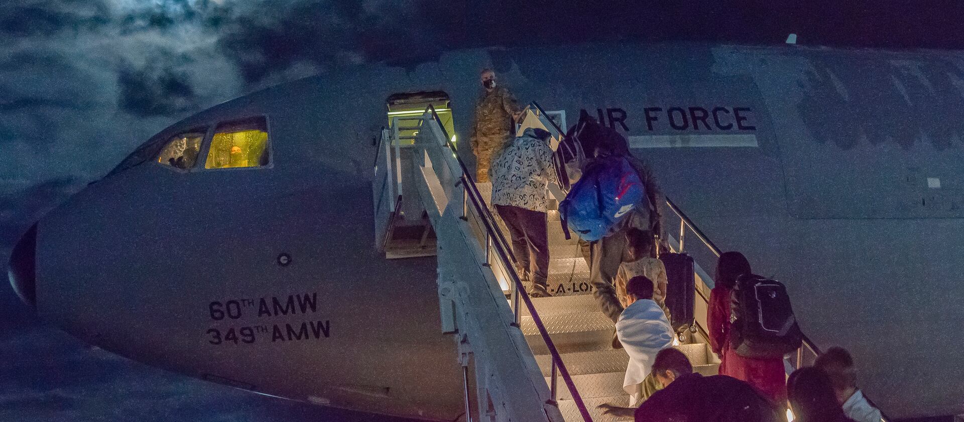 U.S. citizens and their families board a plan to the U.S. in Germany